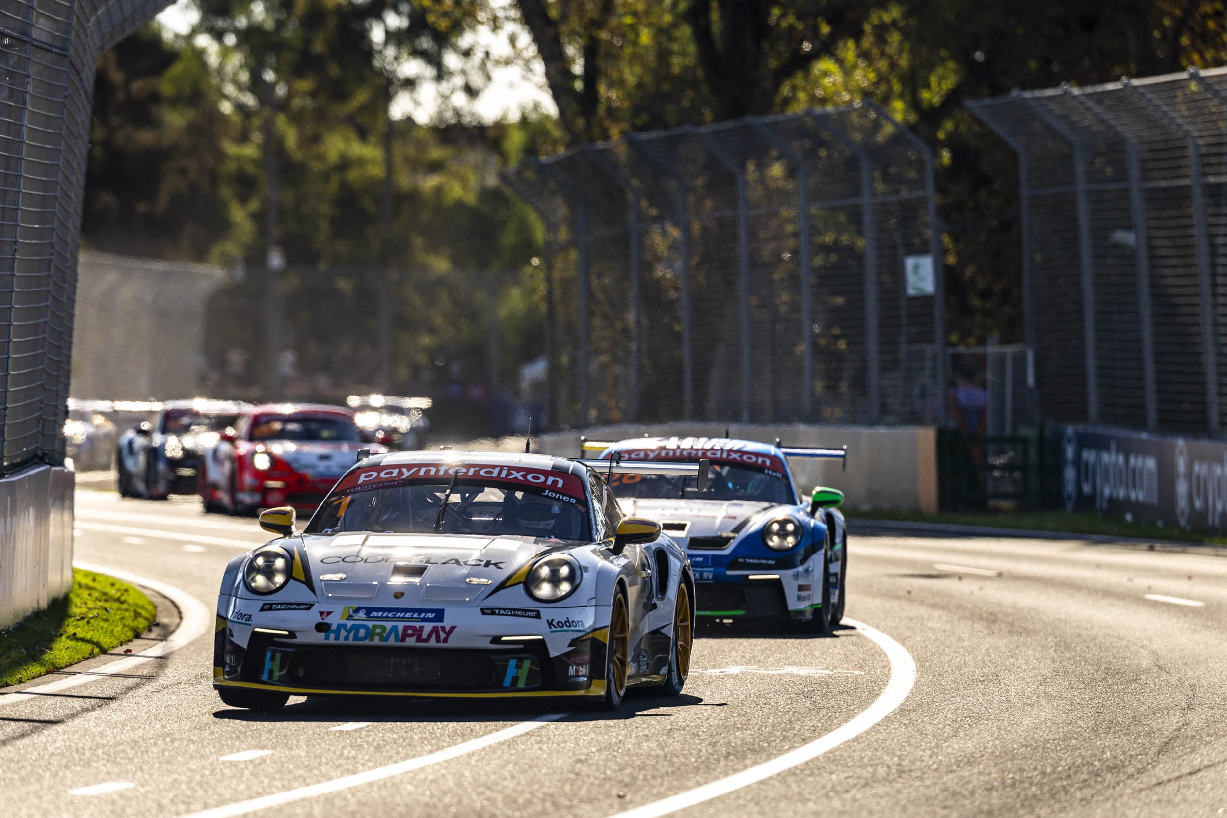 Kodora-liveried Jones Motorsport Porsche 911 leading the Carrera Cup Australia field at the Melbourne round