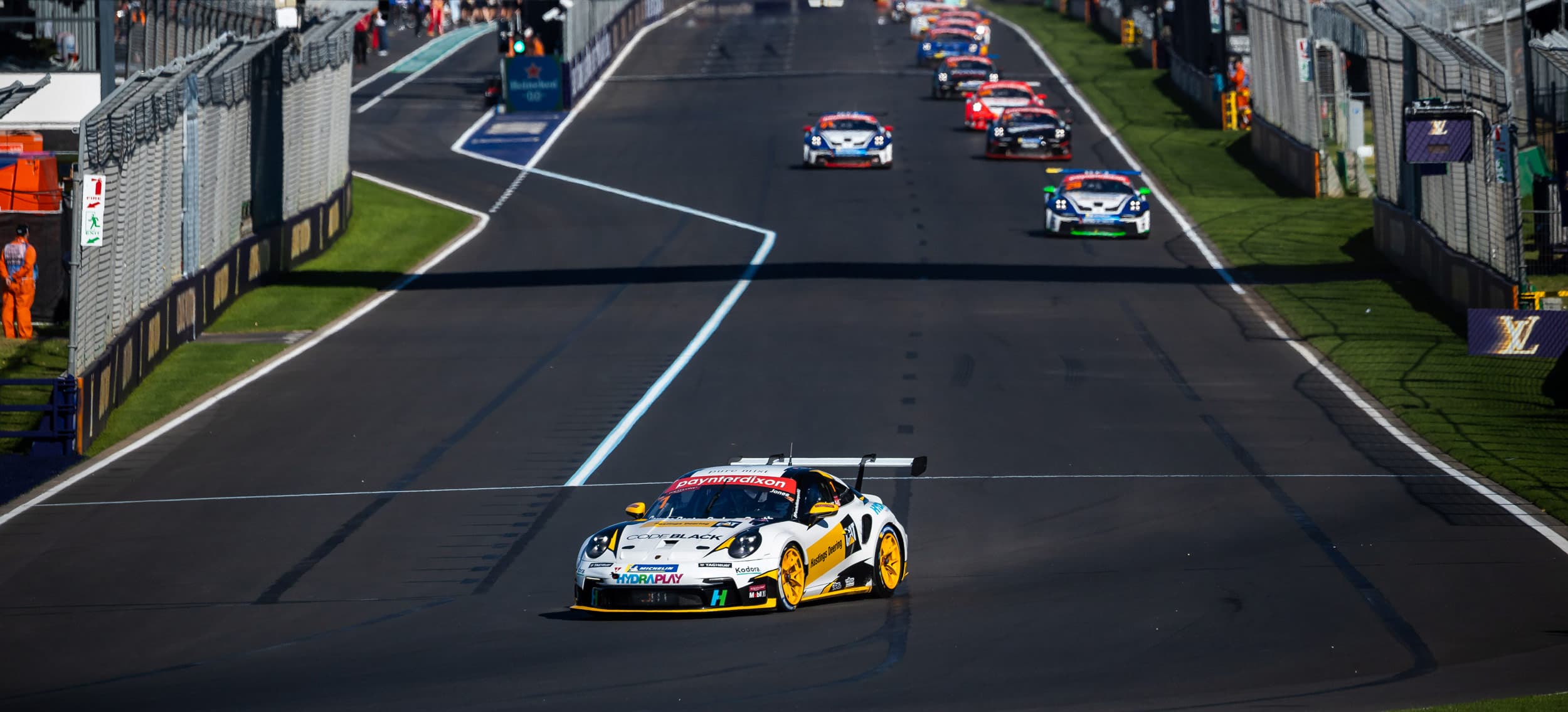 Kodora-liveried Jones Motorsport Porsche 911 at speed during a Carrera Cup Australia round